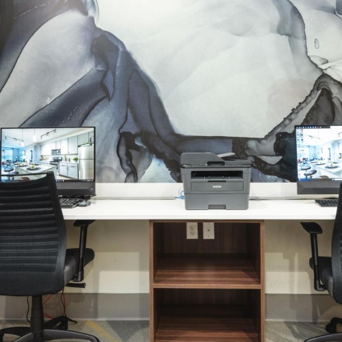 a desk with a computer and a chair in front of it